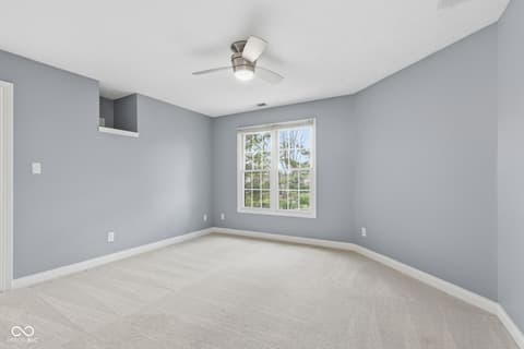 Bedroom at 13867 Smokey Ridge Drive, Carmel, IN — Bright bedroom with large windows and fresh finishes.