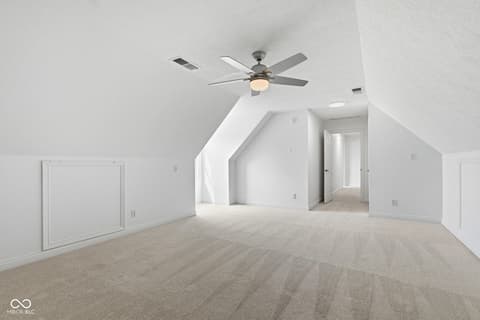 Bonus room at 13867 Smokey Ridge Drive, Carmel, IN — Bright, spacious bonus room with vaulted ceilings.