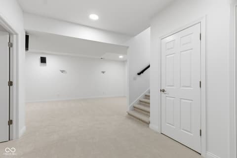 Basement at 13867 Smokey Ridge Drive, Carmel, IN — Bright, spacious finished basement with modern finishes.