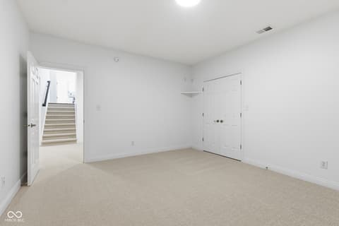 Bedroom at 13867 Smokey Ridge Drive, Carmel, IN — Bright, spacious bedroom with double closet storage.