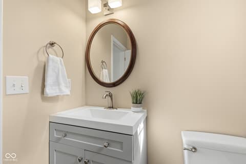 Bathroom at 13867 Smokey Ridge Drive, Carmel, IN — Bright, modern bathroom with quality vanity storage.