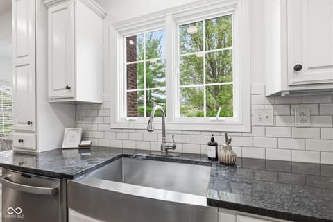 Kitchen at 13867 Smokey Ridge Drive, Carmel, IN — Bright kitchen with granite counters and large windows.