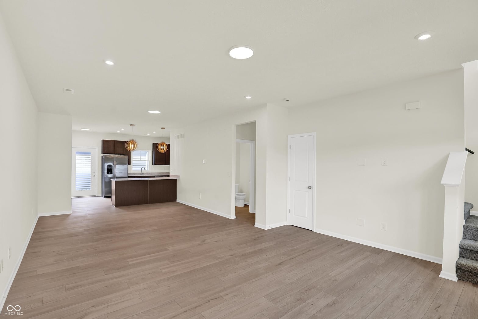 Bright open concept with modern kitchen and hardwood floors.