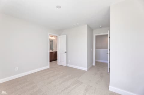 Primary bedroom at 2412 N Keenan Circle, Westfield, IN — Spacious primary suite with ensuite bath and closet space.