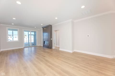 Living room at 2412 N Keenan Circle, Westfield, IN — Bright open living space with fireplace and balcony access.