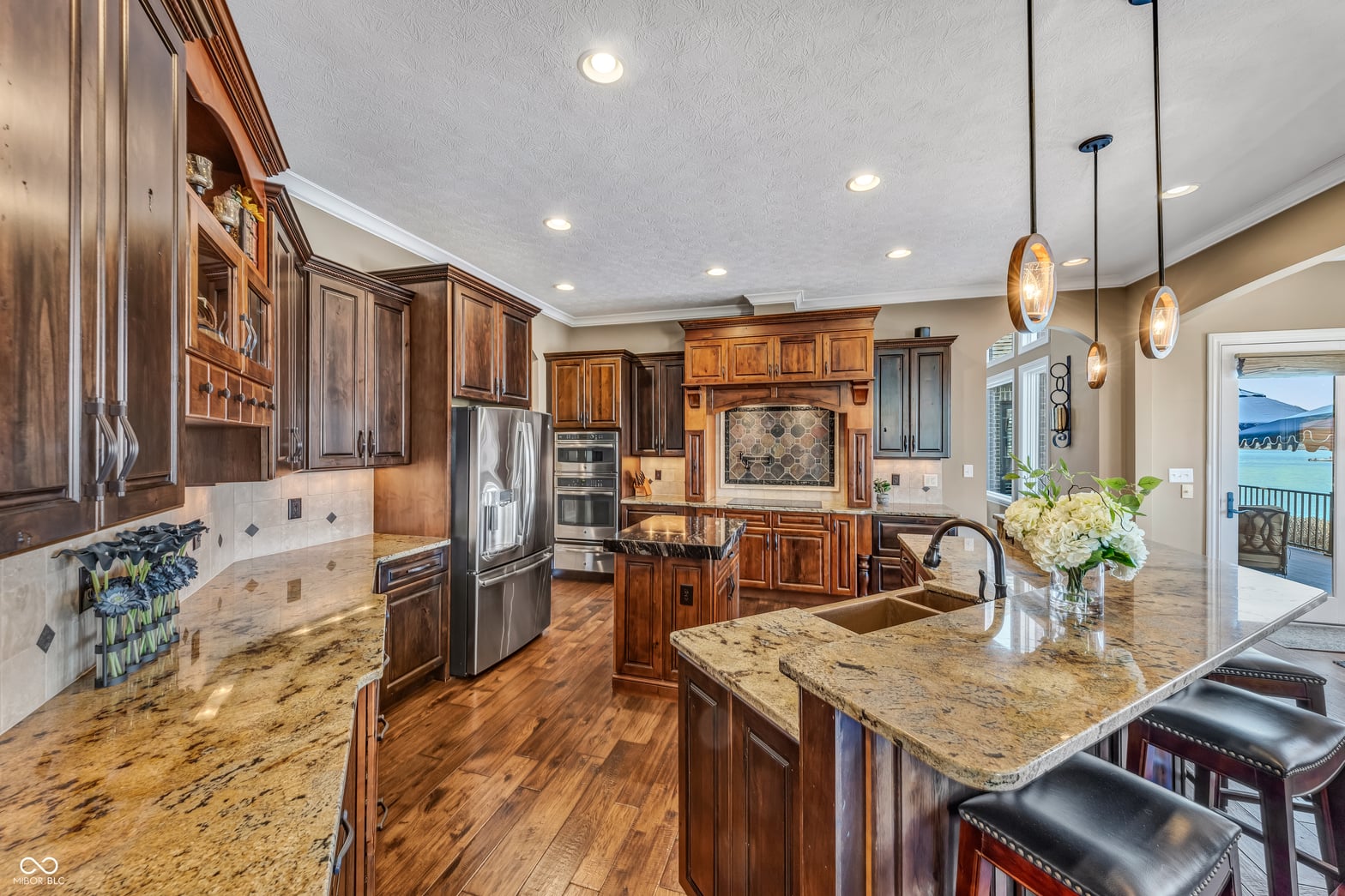Luxurious kitchen with granite counters and quality cabinetry.