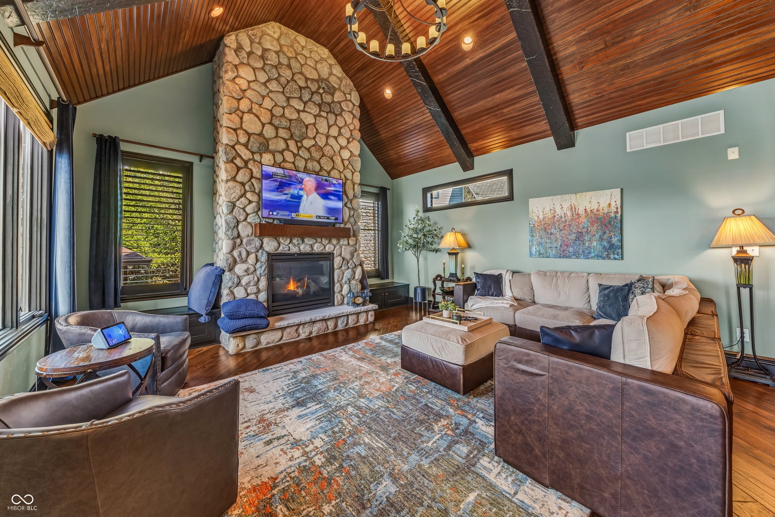 Stunning family room with soaring wood ceilings and stone fireplace.
