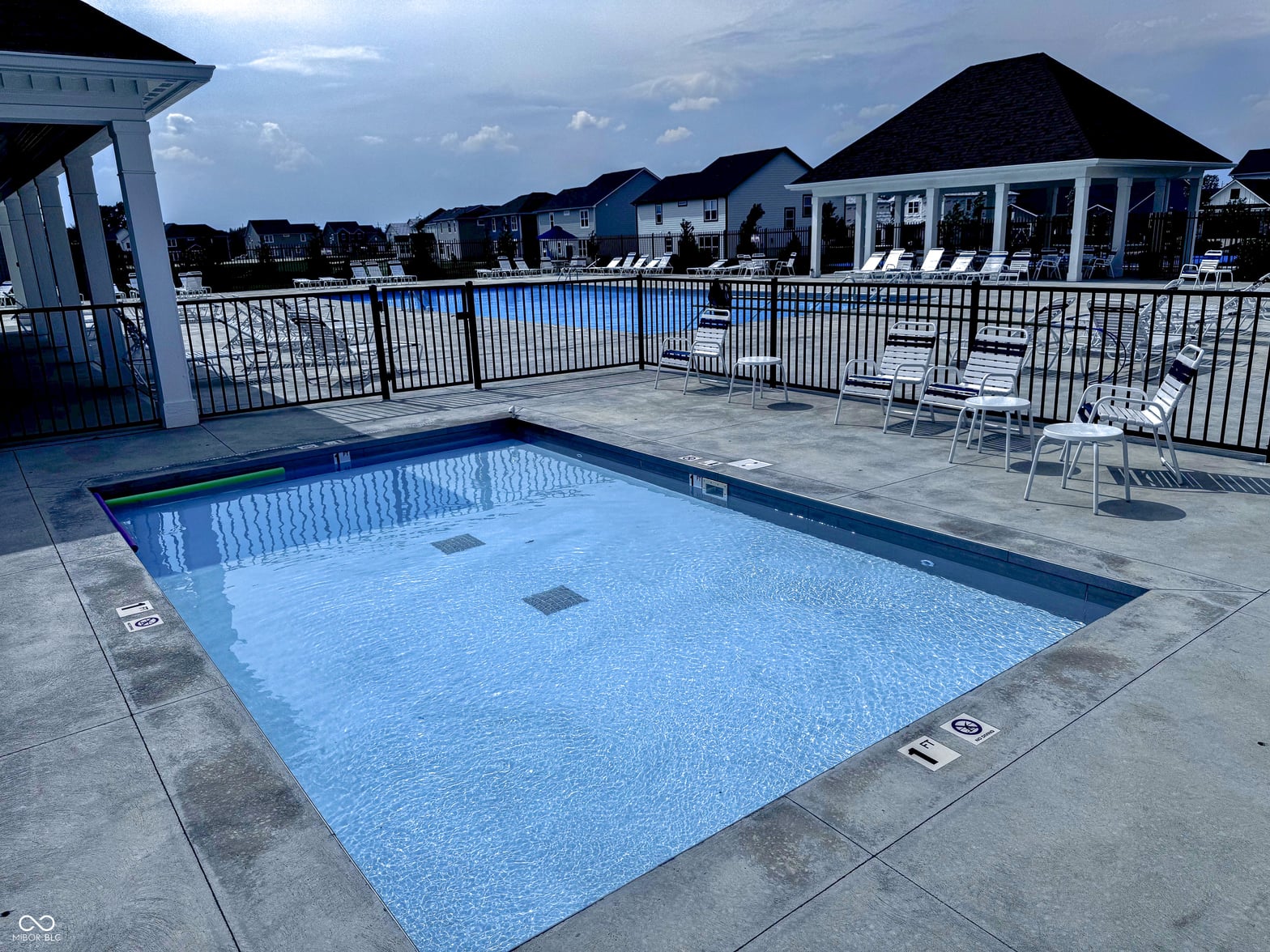 Resort-style community pool with modern amenities and gazebo.