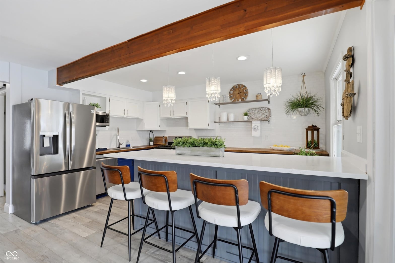 Modern kitchen with exposed beams and island seating.