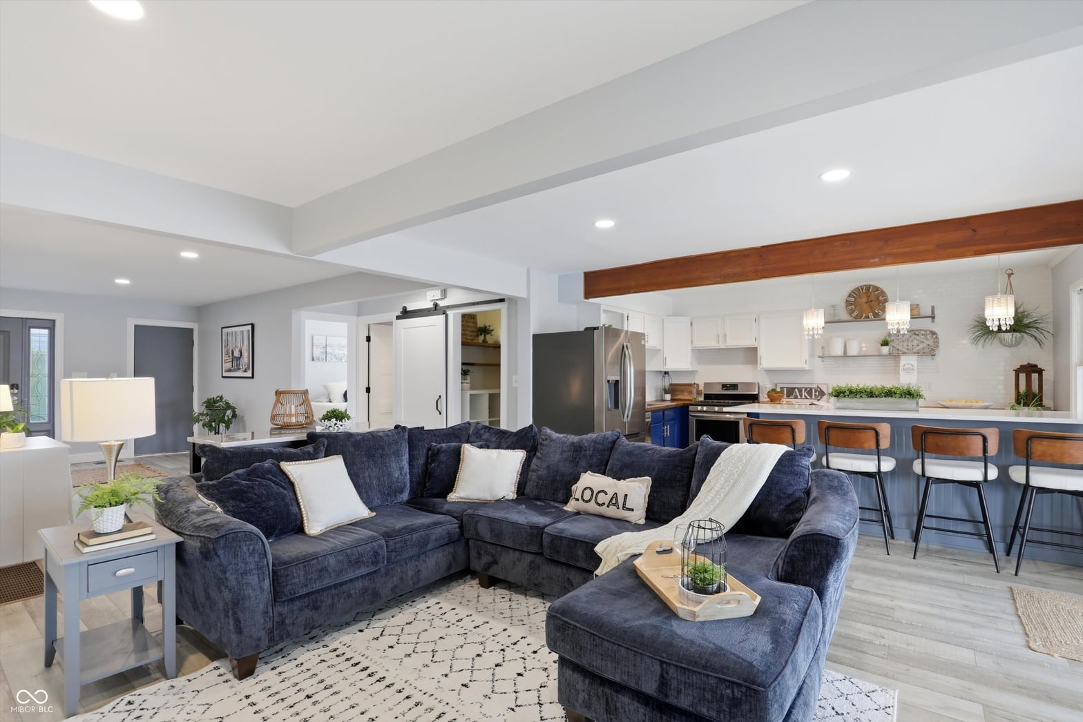 Bright open-concept living with modern finishes and coffered ceilings.