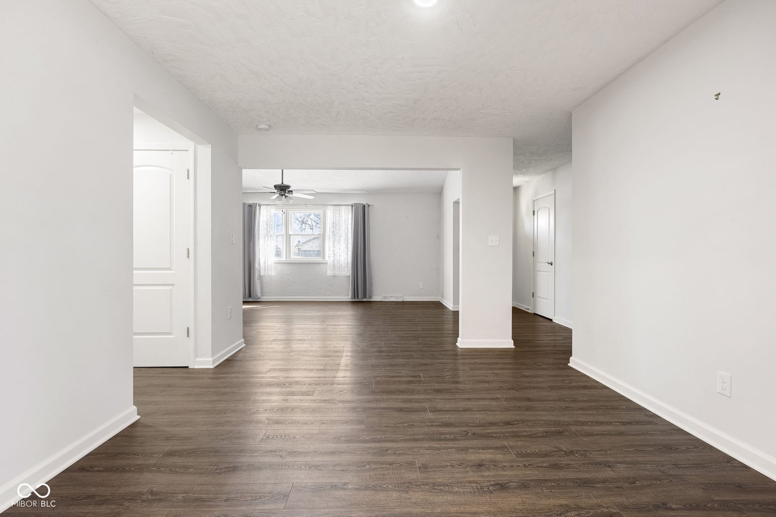 Open, bright family room with fresh hardwood flooring.