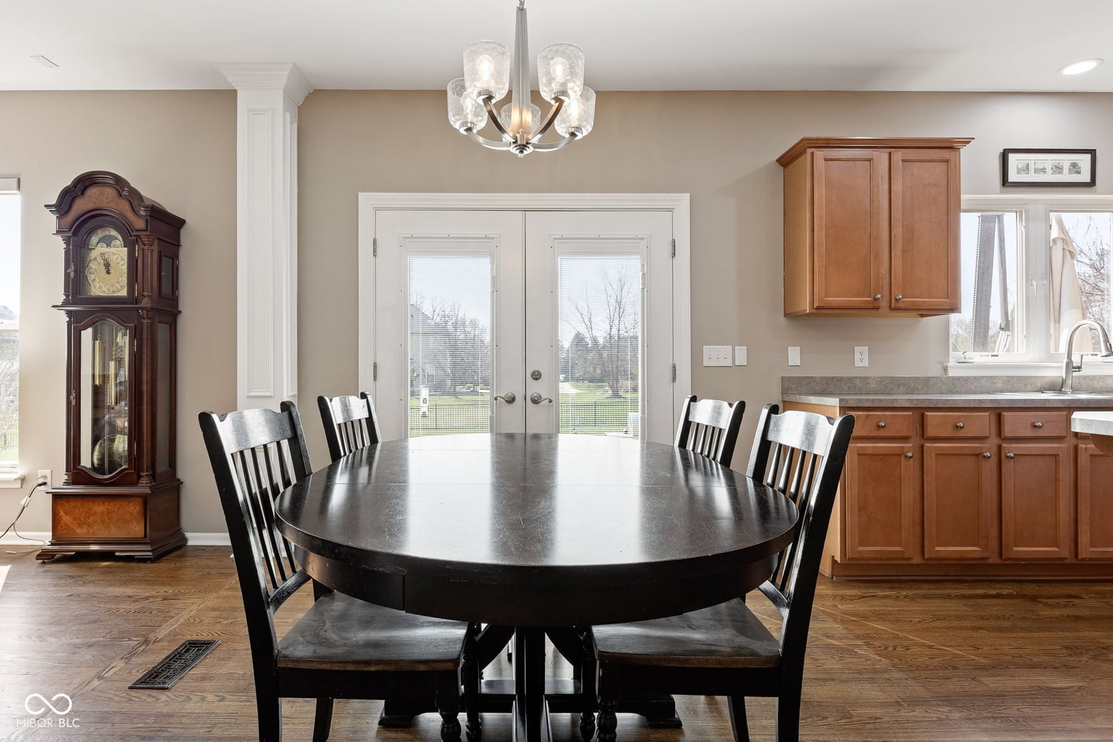 Elegant dining room with French doors and open kitchen layout.