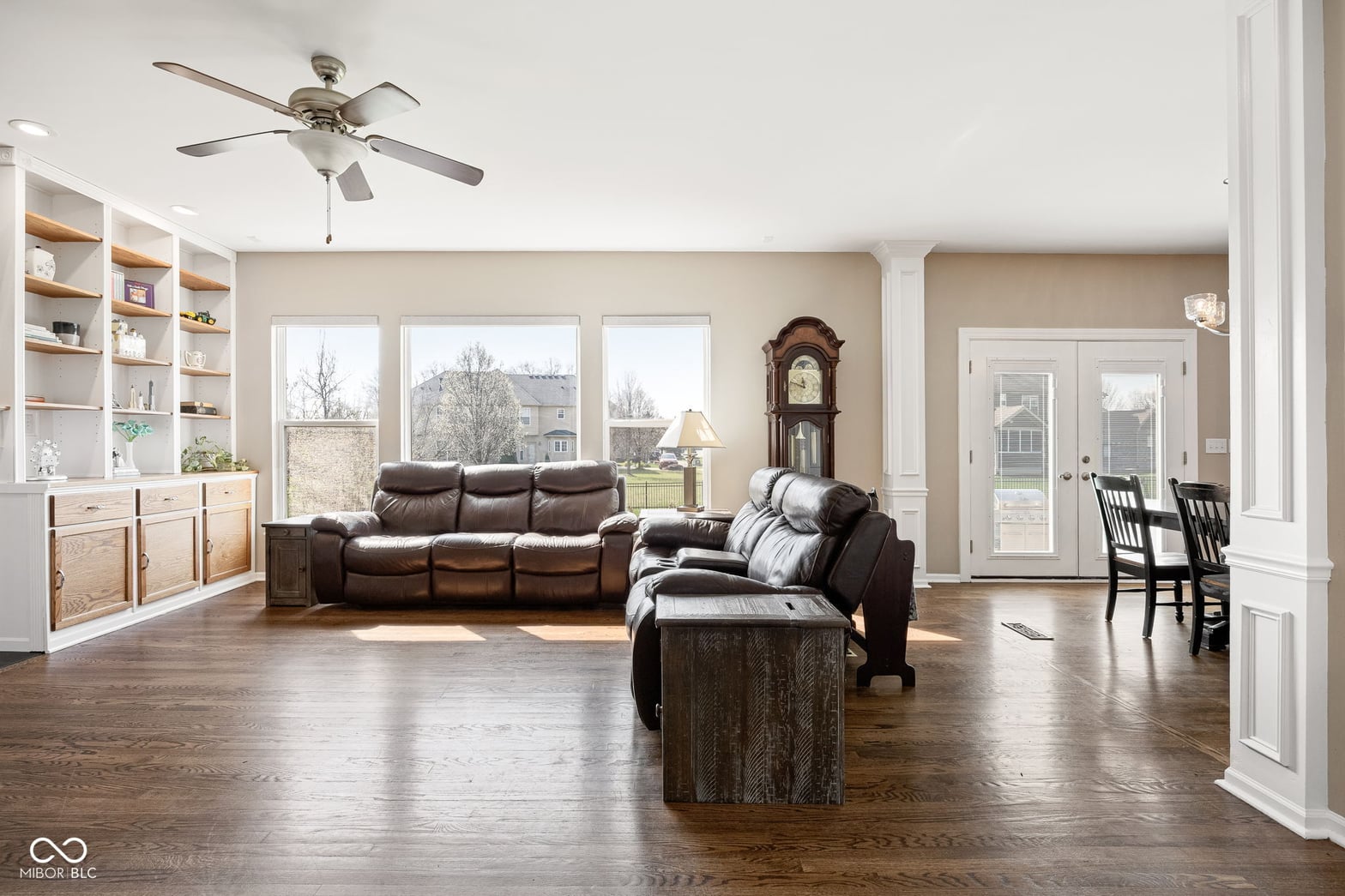 Spacious living room with hardwood floors and built-in storage.