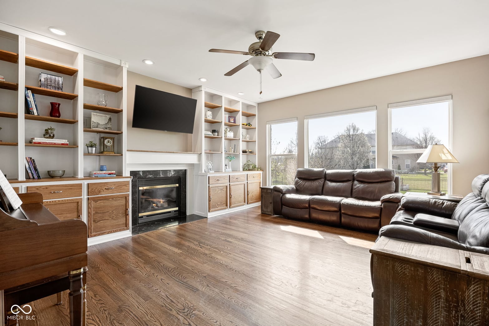 Spacious family room with fireplace and custom built-ins.