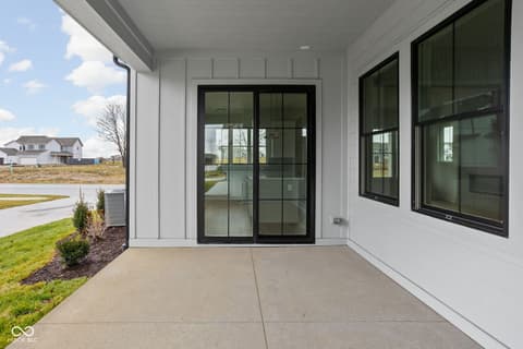 Outdoor living area at 1654 Delmonte Rail Drive, Westfield, IN — Spacious covered patio with modern black-framed doors.