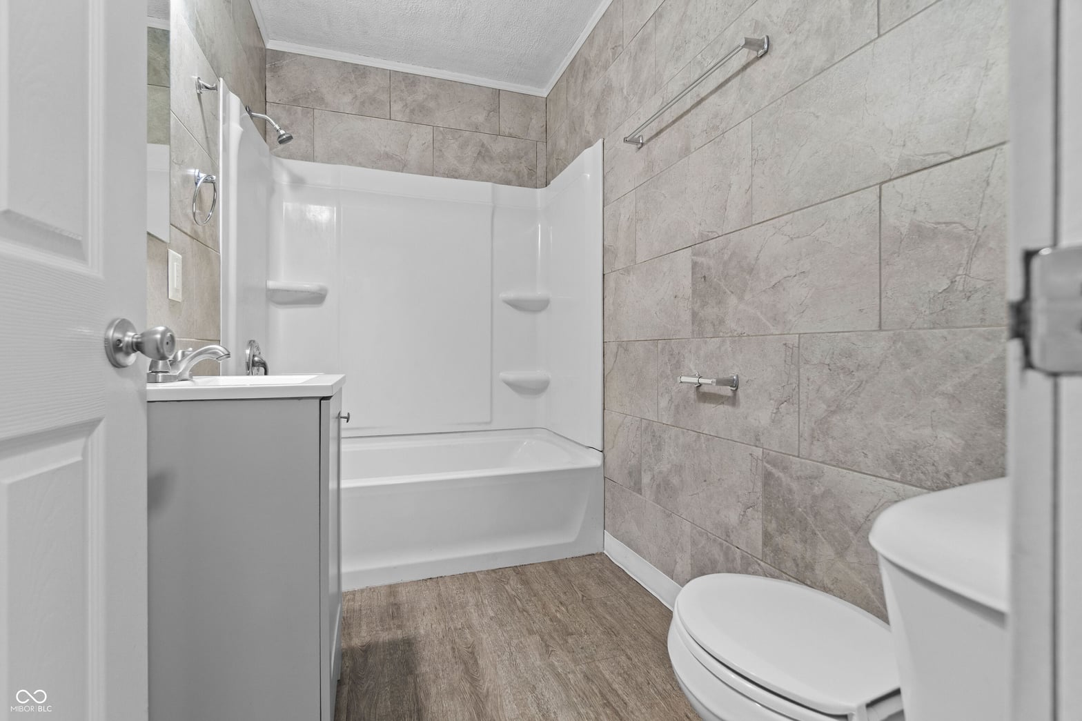 Modern bathroom with ceramic tile and updated fixtures.
