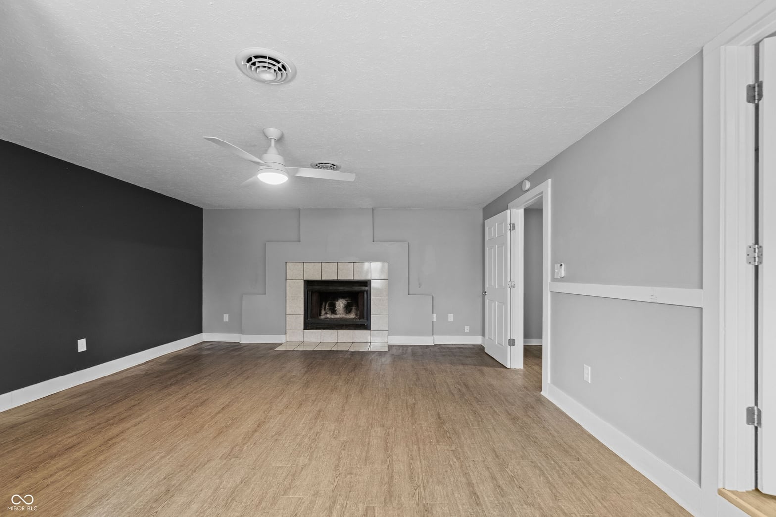 Spacious family room with fireplace and modern updates.