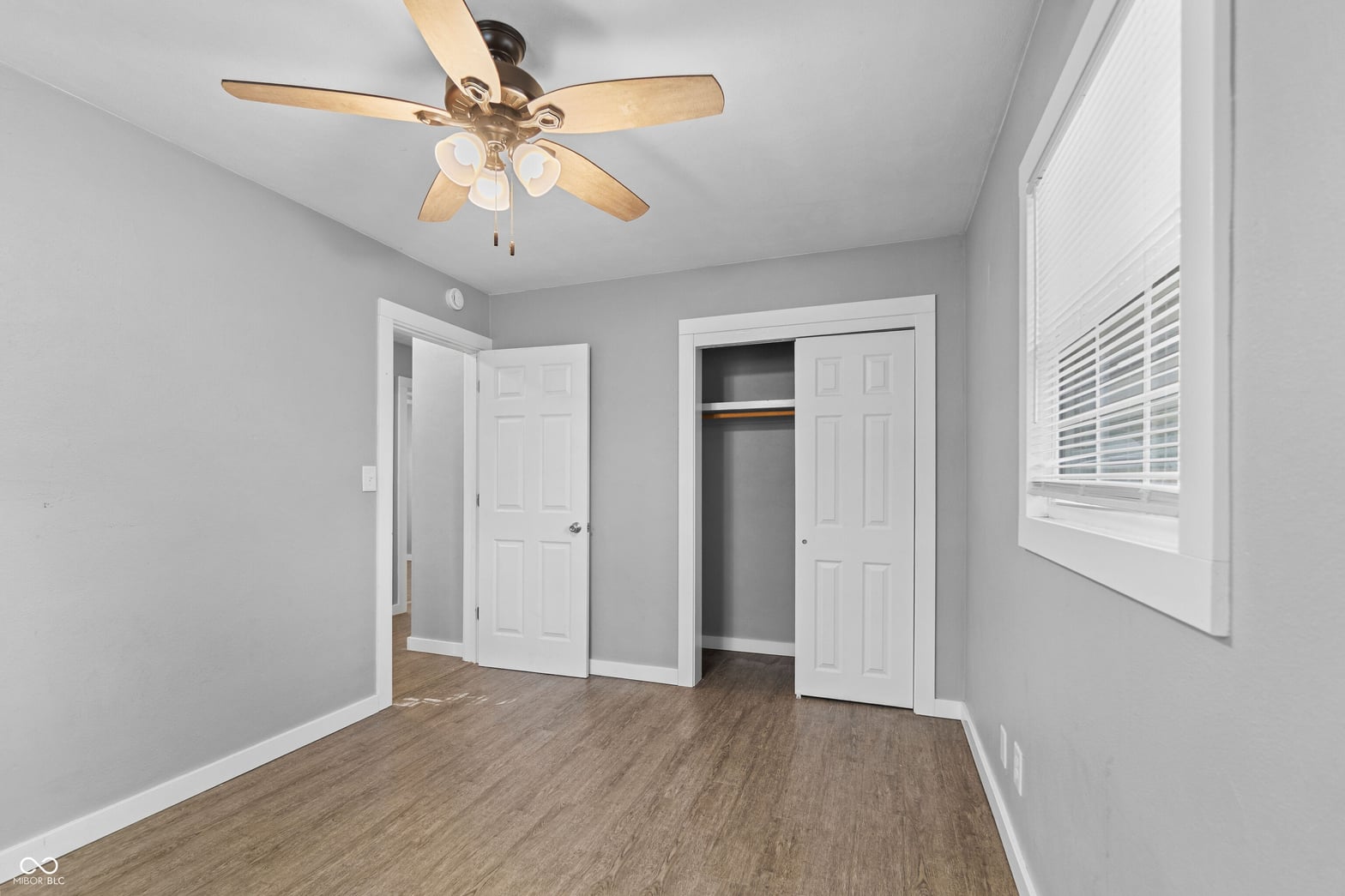 Spacious primary bedroom with dual closets and natural light.