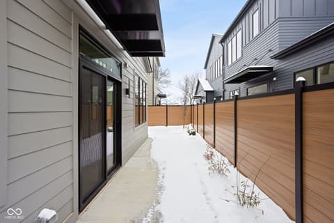 Side exterior at 1676 Coach Drive, Westfield, IN — Modern side yard with composite fencing and patio access.