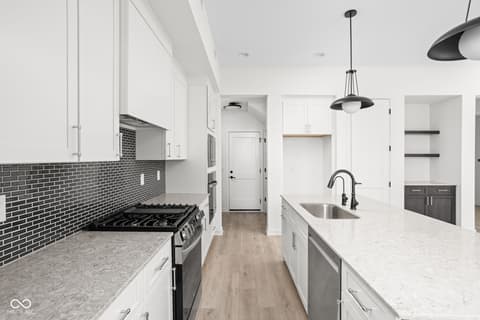 Kitchen at 1676 Coach Drive, Westfield, IN — Modern kitchen with white cabinetry and black accents.