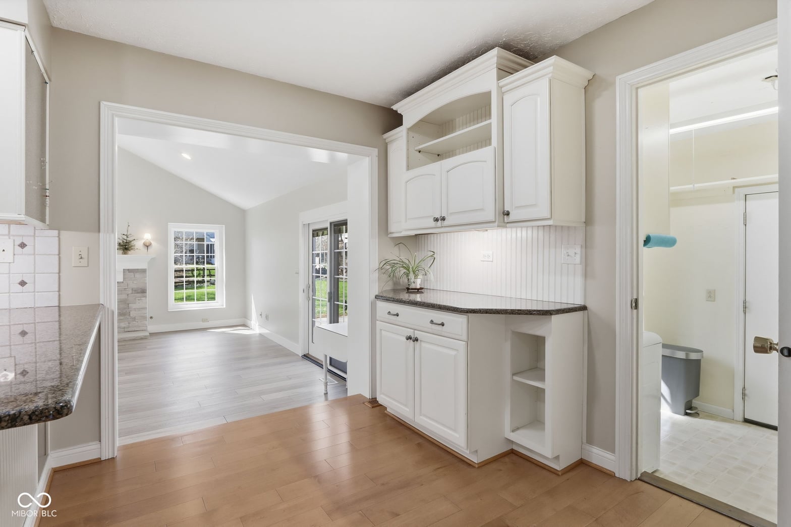 Bright, updated kitchen with white cabinetry and hardwood floors.