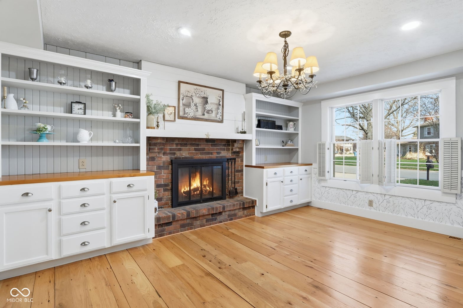 Bright living room with working fireplace and built-ins.