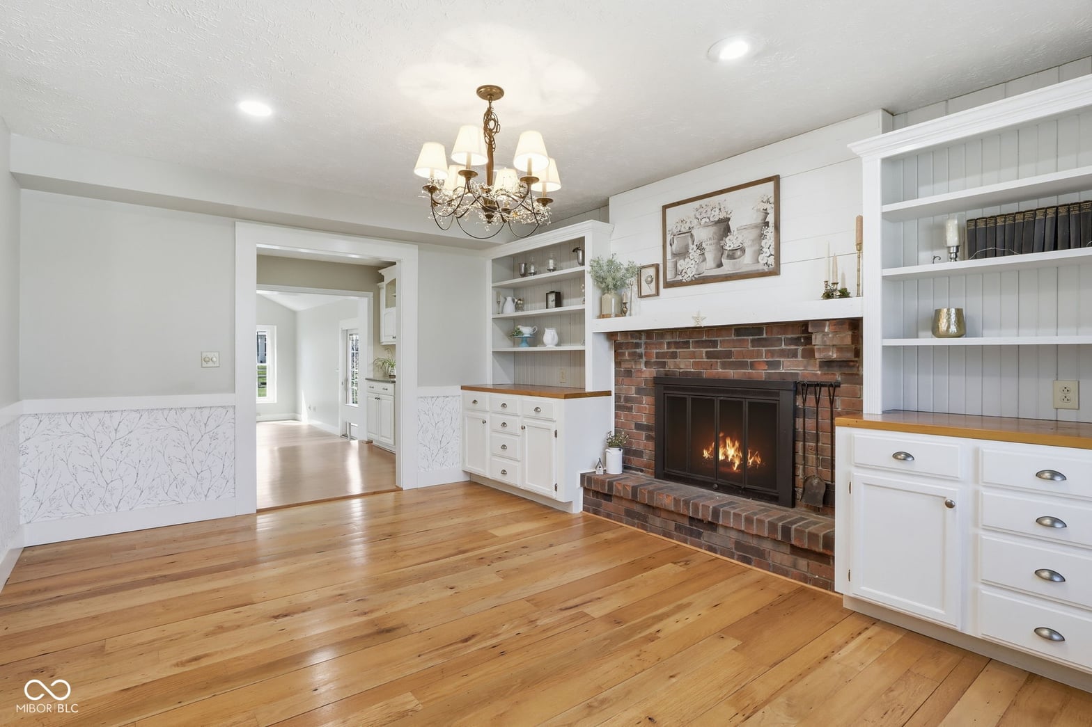 Charming family room with brick fireplace and built-ins.