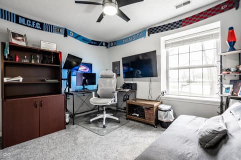 Bonus room at 450 E Pine Ridge Drive, Westfield, IN — Modern bonus room with gaming setup and bedroom combination.