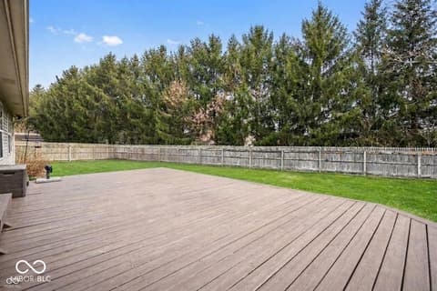 Backyard at 450 E Pine Ridge Drive, Westfield, IN — Spacious composite deck with private, tree-lined backyard.