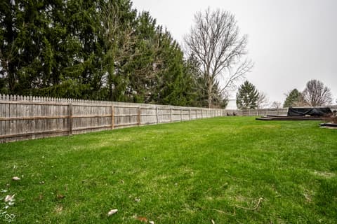 Yard at 450 E Pine Ridge Drive, Westfield, IN — Large fenced yard with mature trees and privacy.