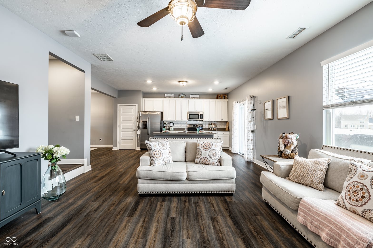 Bright open living space with updated kitchen and hardwood floors.