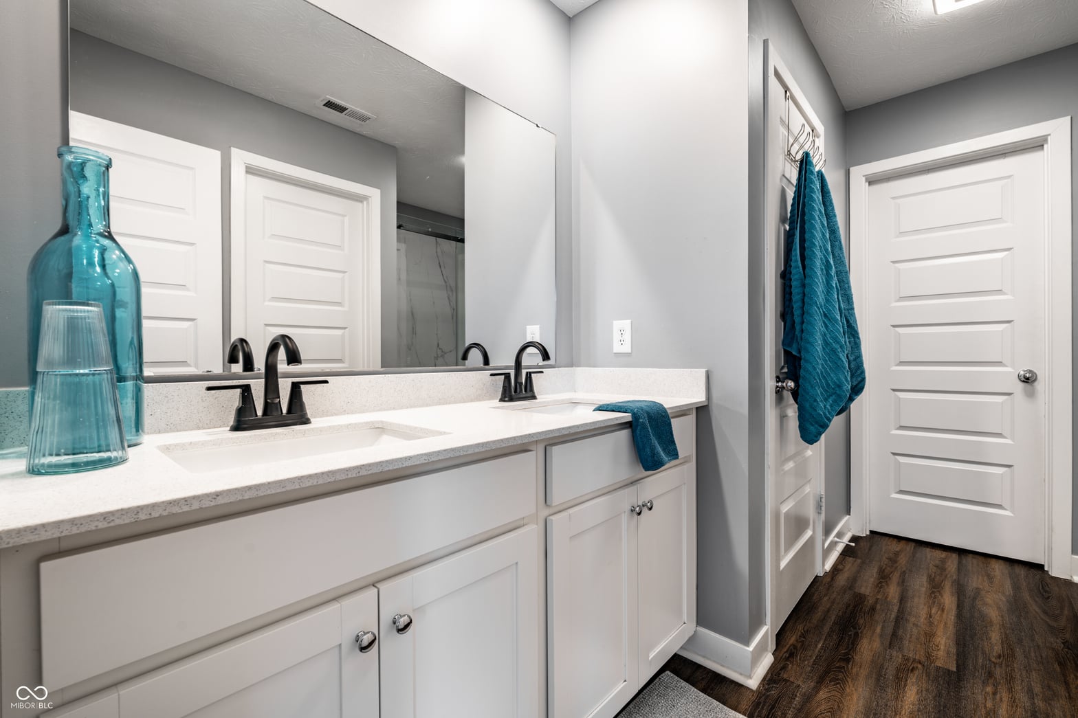 Spacious primary bath with double vanity and modern finishes.
