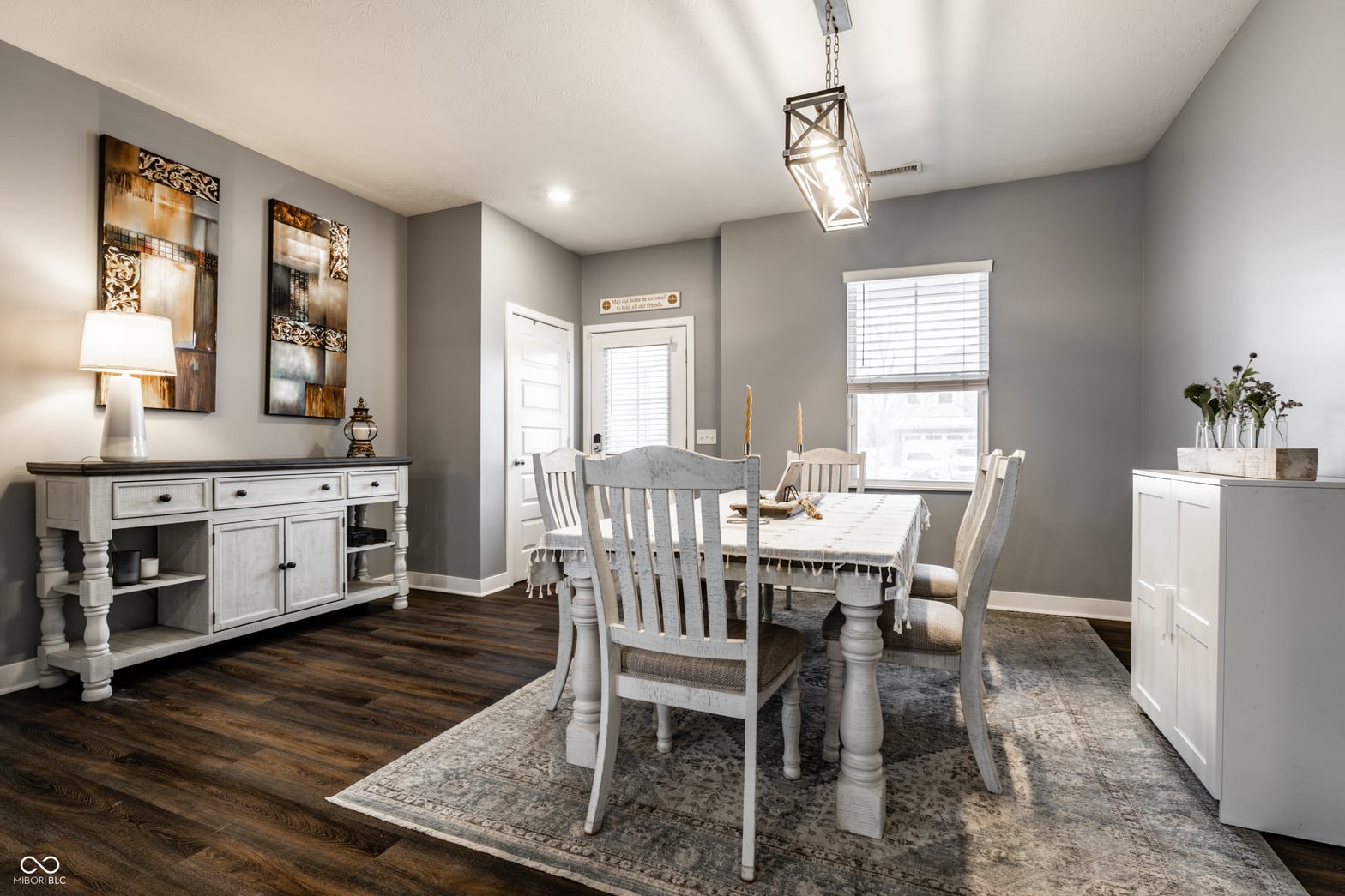 Bright farmhouse dining room with hardwood floors and natural light.