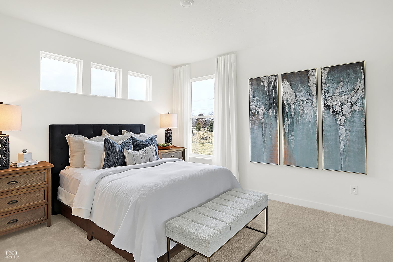 Bright primary suite with expansive windows and modern finishes.