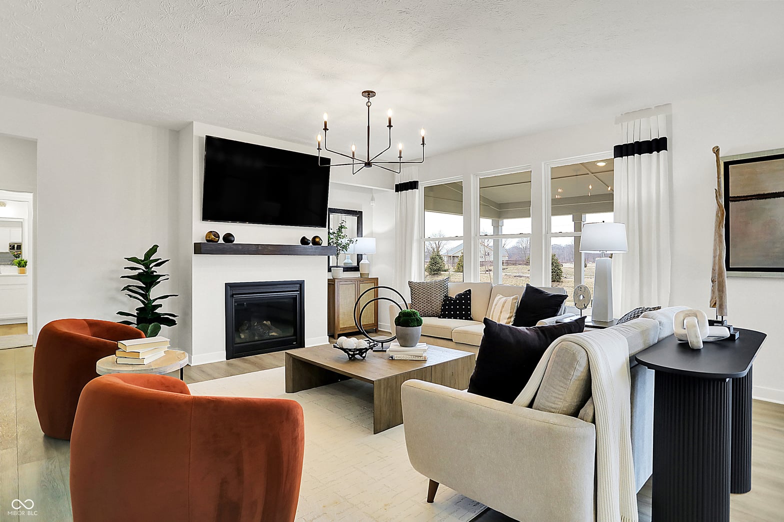 Bright contemporary living room with fireplace and mountain views.