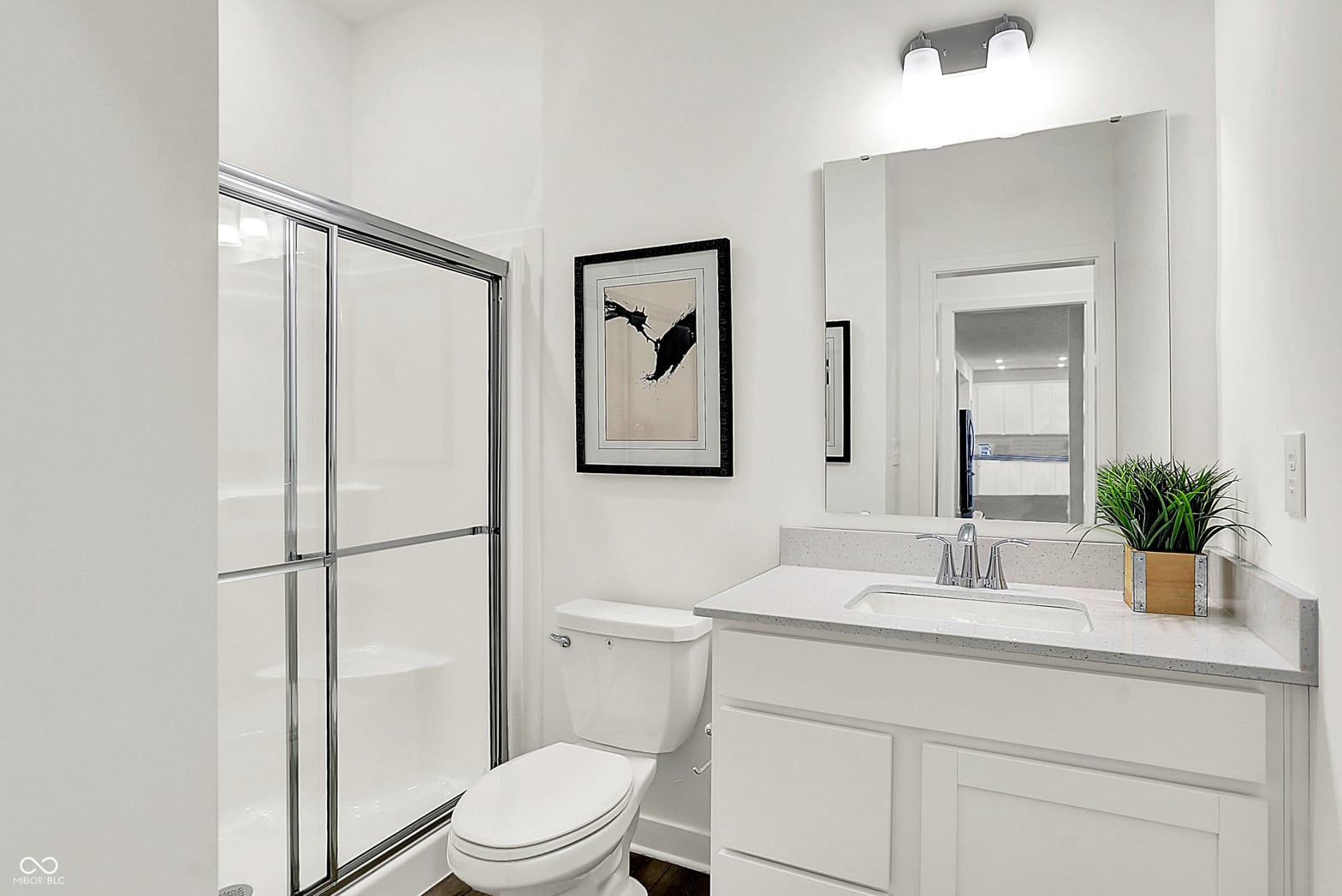 Bright, updated primary bathroom with modern finishes throughout.