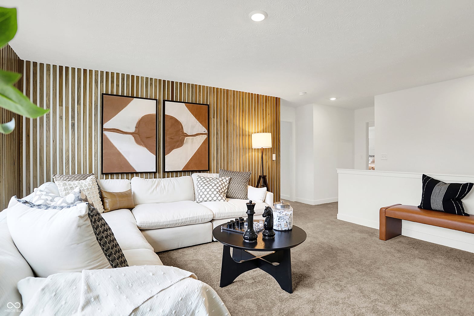 Spacious contemporary family room with stylish wood accent wall.