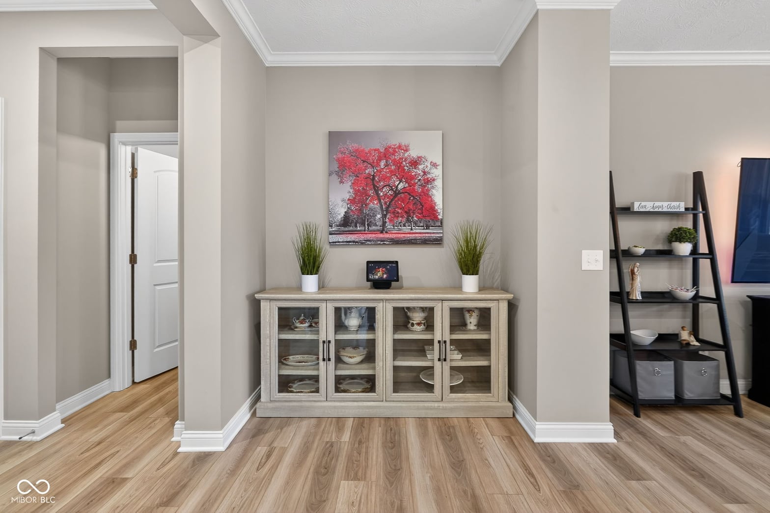 Modern dining space with elegant storage and hardwood floors.