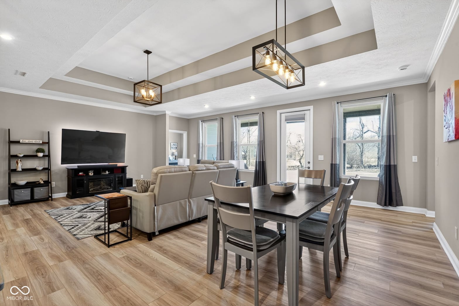 Spacious open-concept living with coffered ceilings and views.