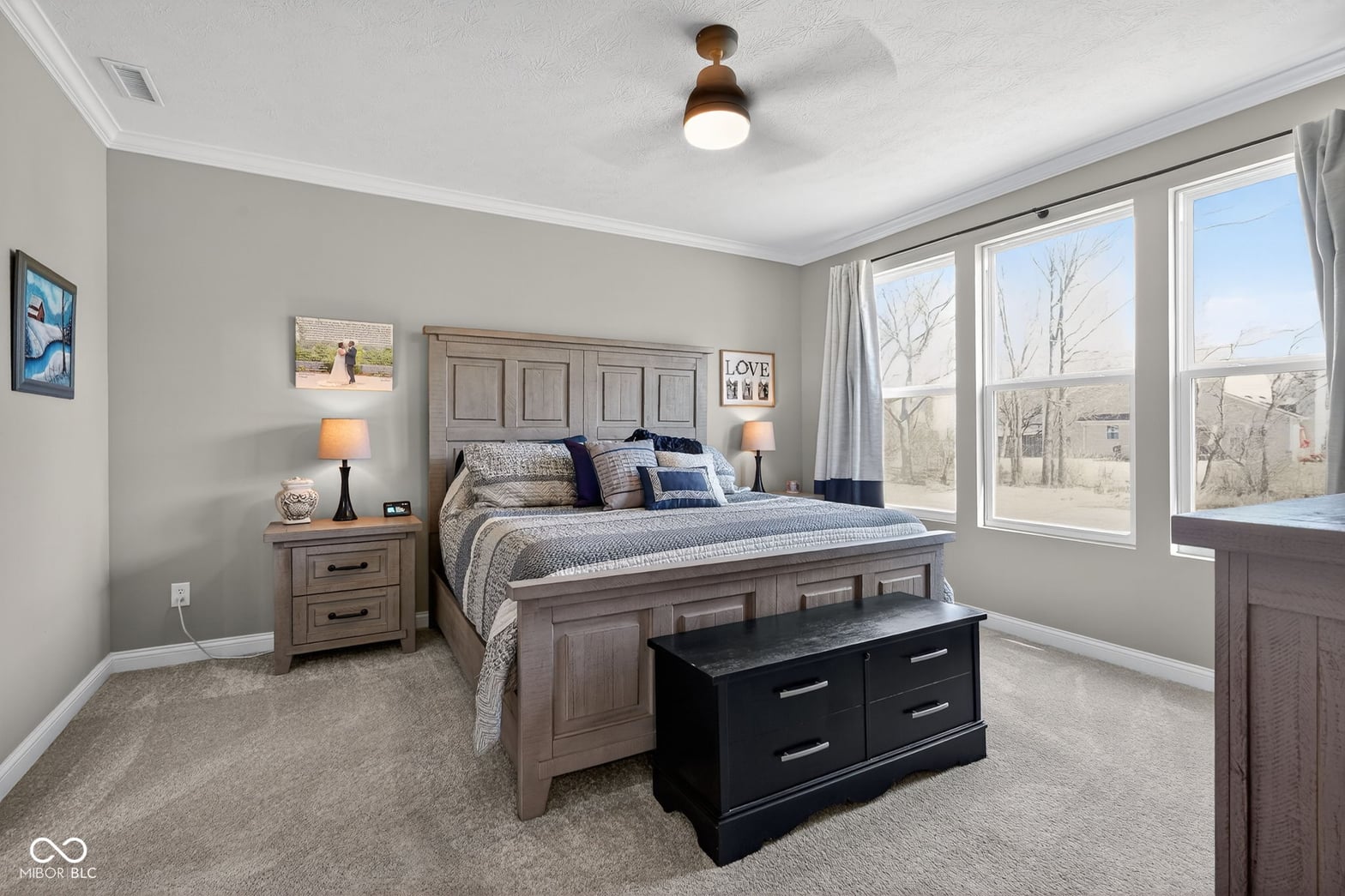 Bright primary suite with expansive windows and quality finishes.