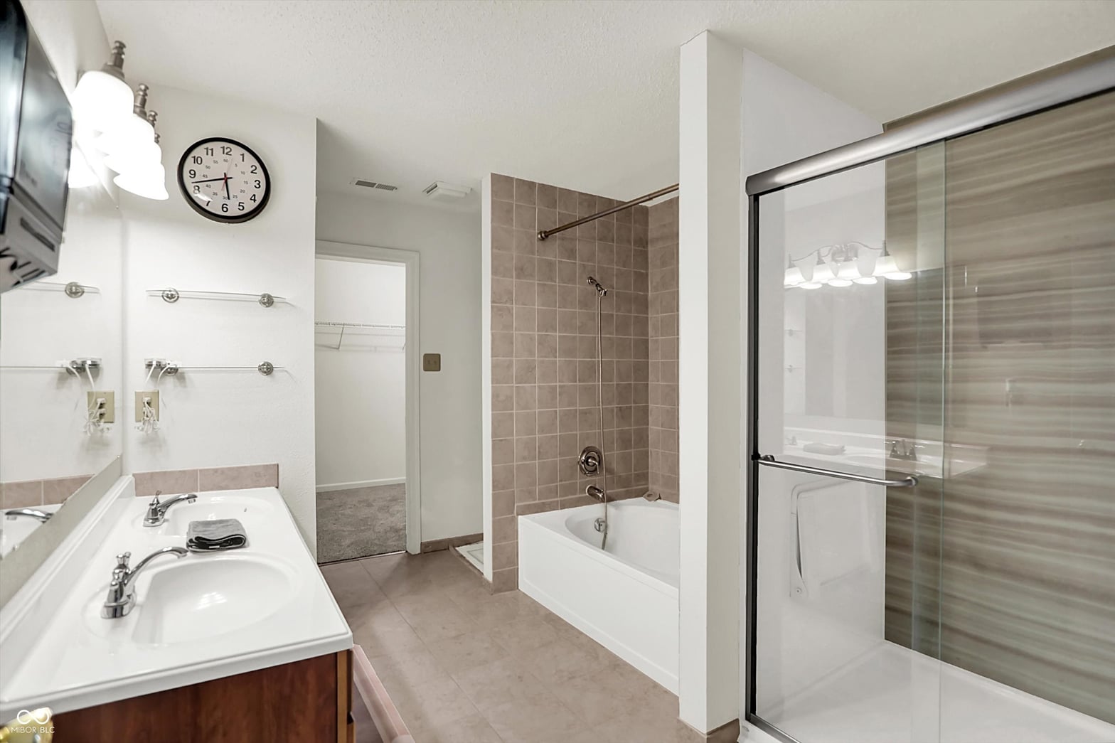 Spacious primary bath with dual vanity and separate shower tub.