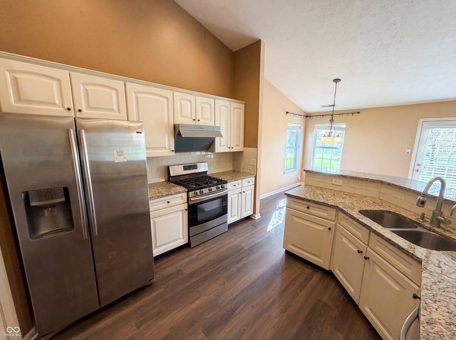 Updated kitchen with granite counters and stainless steel appliances.