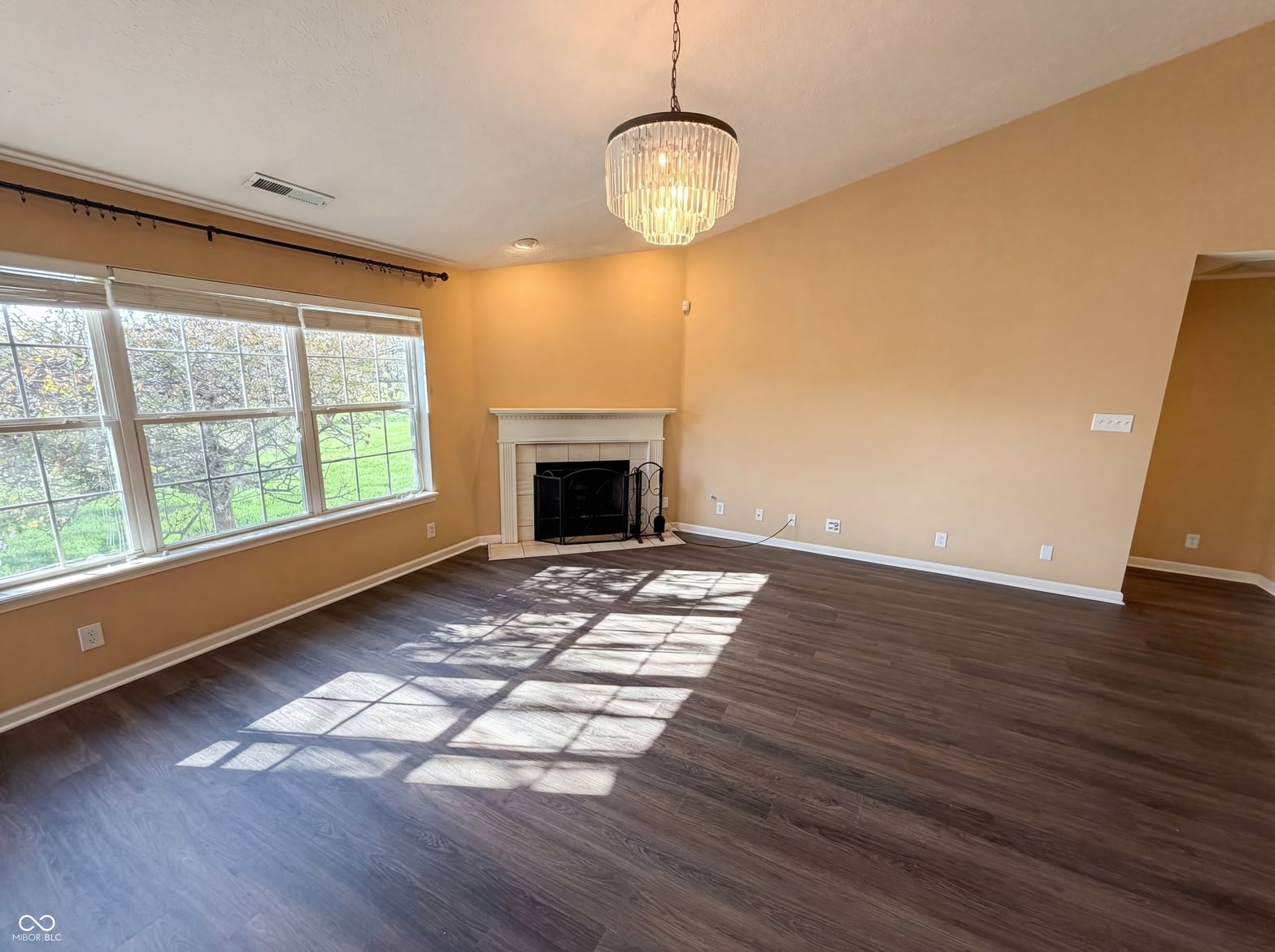 Bright, spacious family room with fireplace and abundant natural light.