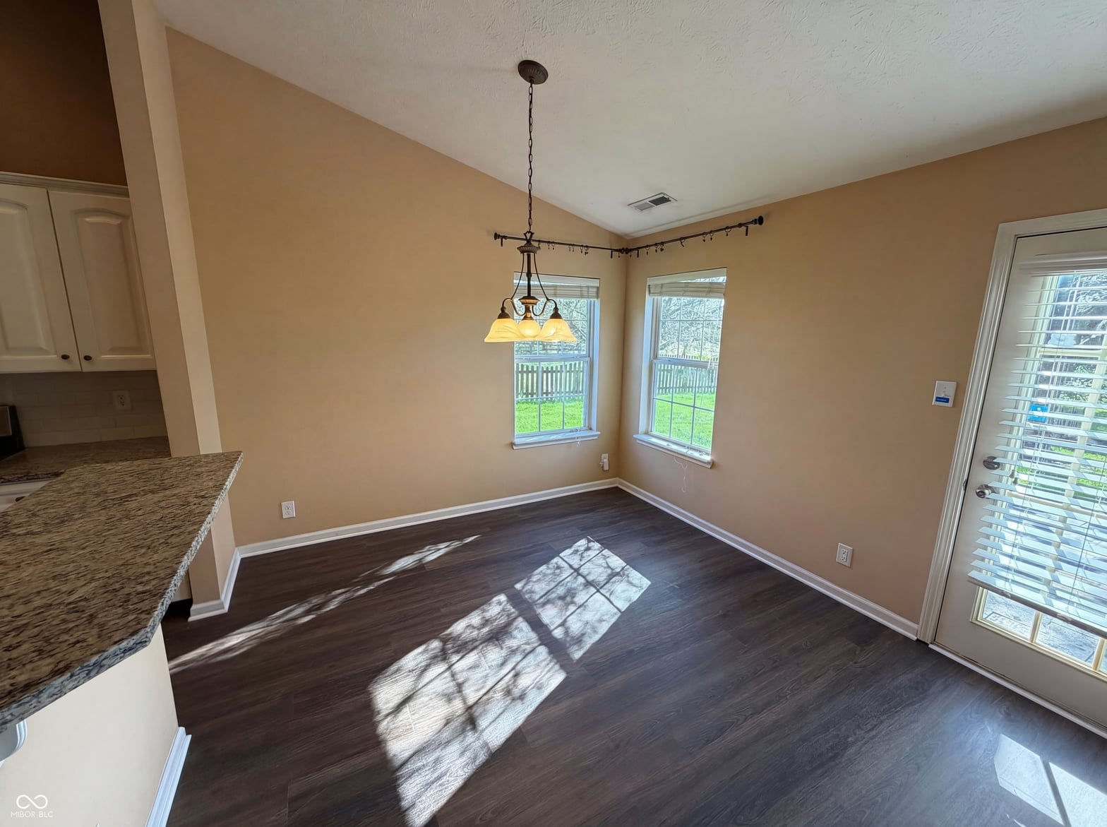 Bright dining space with hardwood floors and natural light