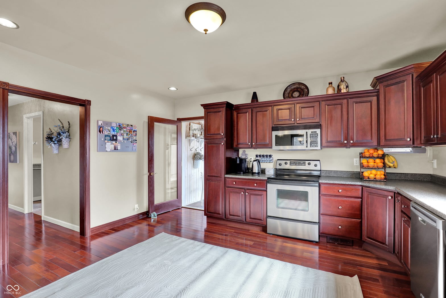 Spacious updated kitchen with cherry cabinets and hardwood floors