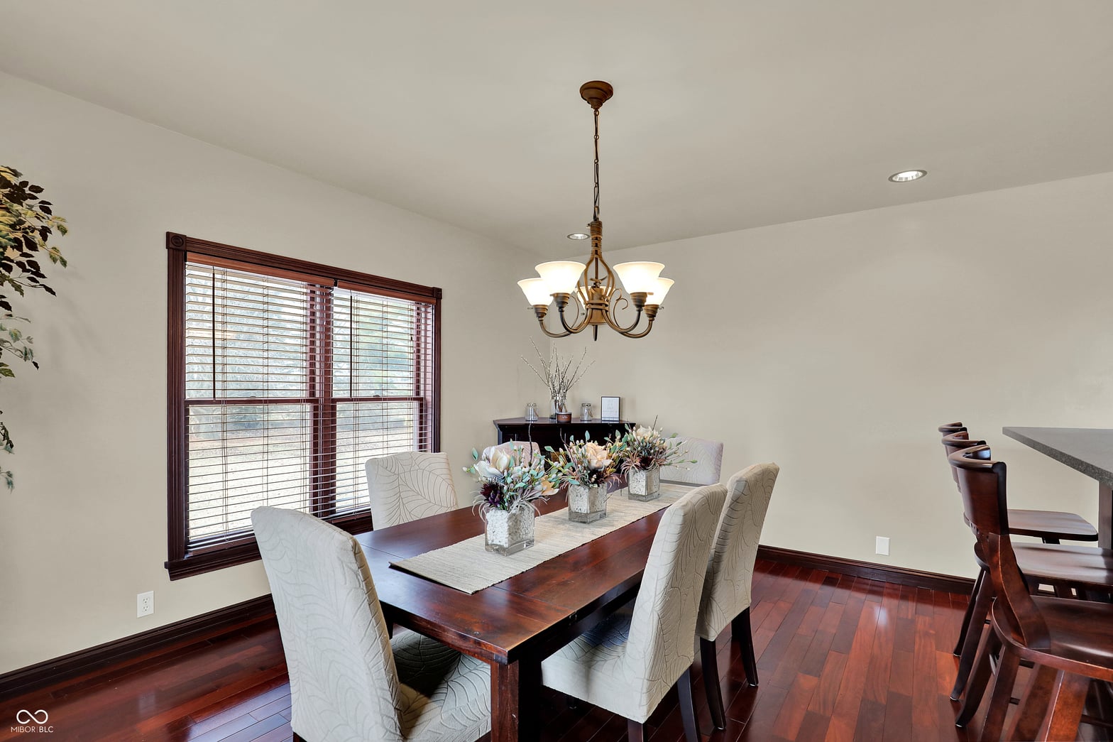 Elegant dining room with hardwood floors and quality fixtures.