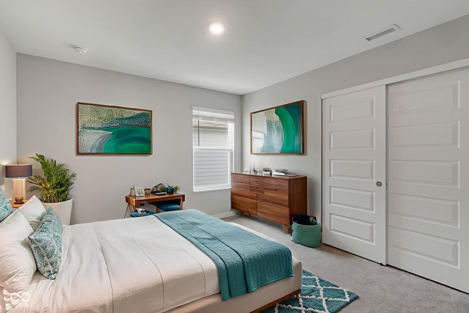 Bright primary bedroom with ample closet space and modern finishes.