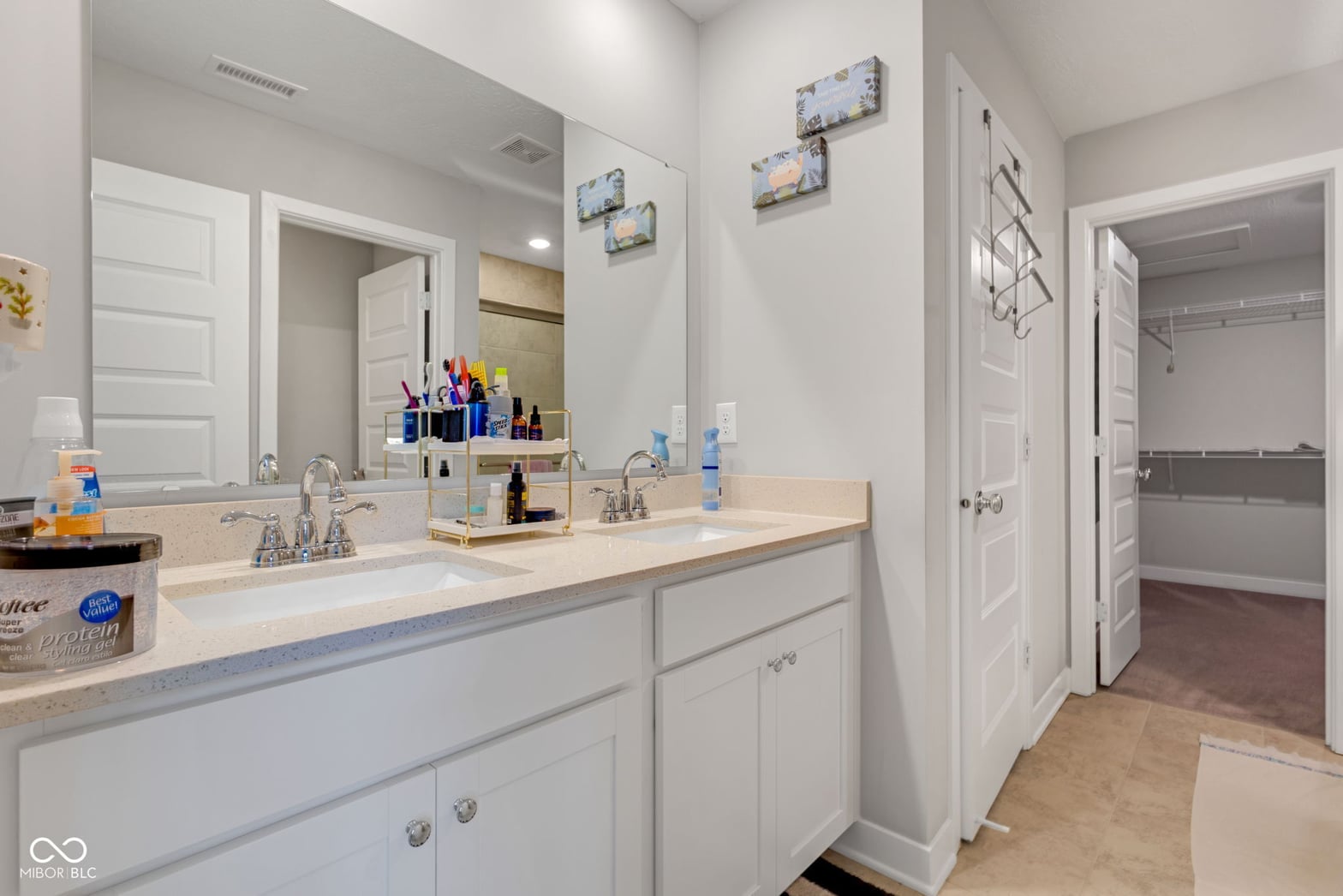 Spacious primary bath with double vanity and quartz counters.