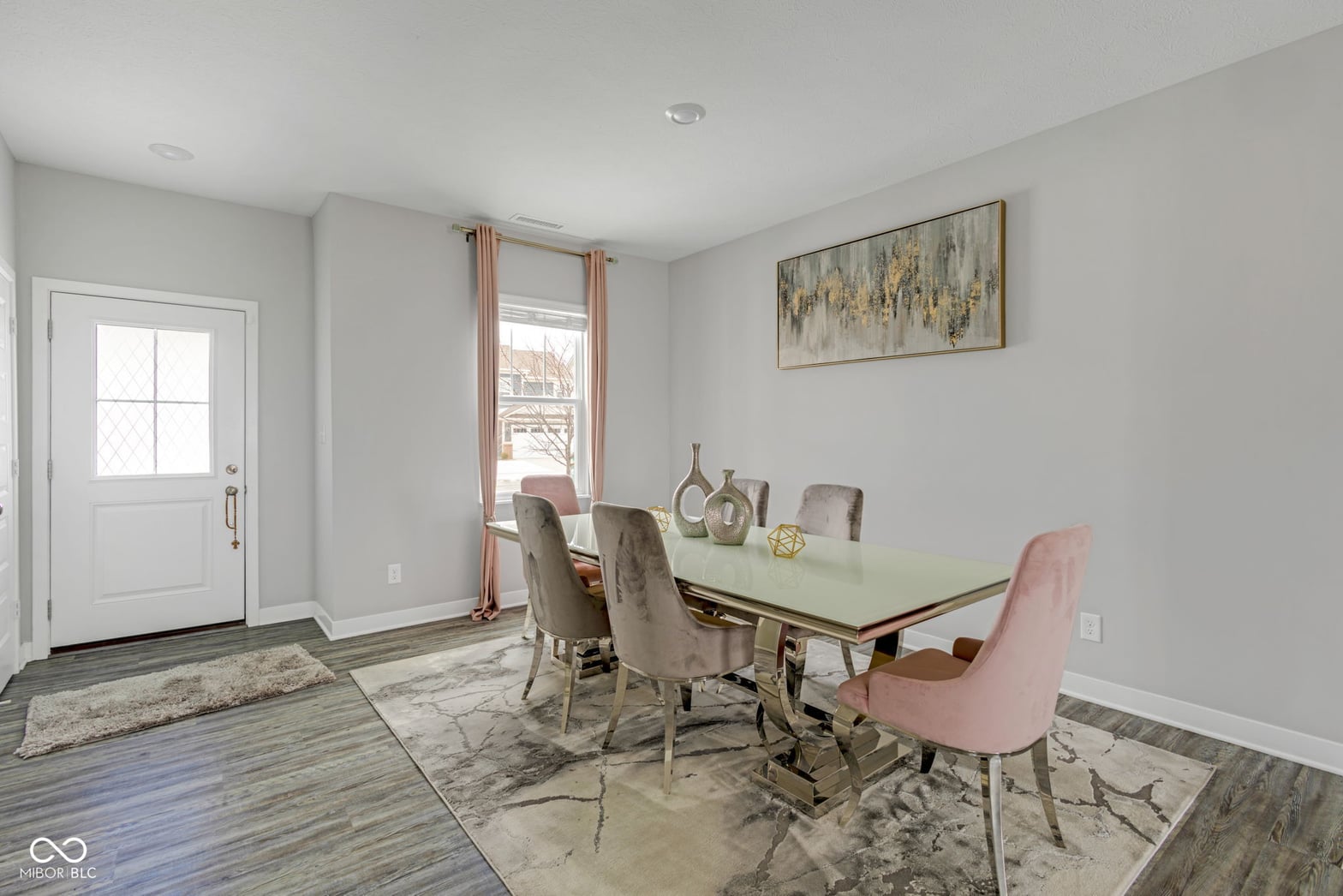 Bright contemporary dining room with modern glass table.