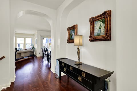 Foyer at 10001 Copper Saddle Bend, Fishers, IN — Elegant foyer with arched entry and hardwood floors.